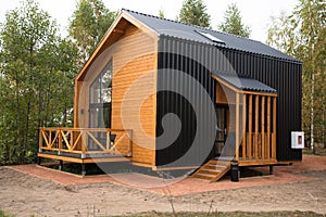 Barnhouse style house. House in the bosom of nature. Greenery and trees