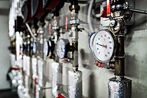 Barometers on pressure pipes, technical room with heat and water distribution