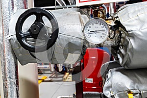 Barometers on pressure pipes, underground premises of the factory with heat and water distribution technology