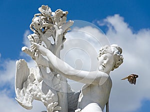 Baroque antique female statue and flying bird