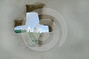 Baroque chapel of Saint Sebastian on Holy hill in Mikulov through hole in wall shaped as a cross, Czech Republic