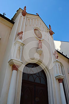 Baroque entrance to monastery next to the Church Of The Holy Trinity in Trnava, western Slovaia, decorated with statues of angels