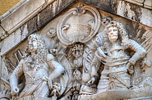 Baroque relief of long-haired armored men on Clock Tower Rijeka