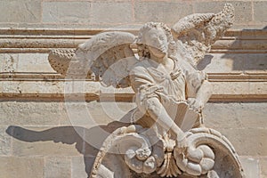 Baroque statue of angel decorating the facade of church