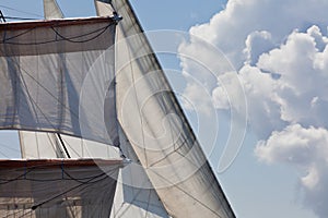 Barquentine yacht sails rigging clouds background