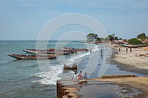 BARRA, THE GAMBIA - NOVEMBER 18, 2019: Pleople workingh at the beach in Barra, Gambia