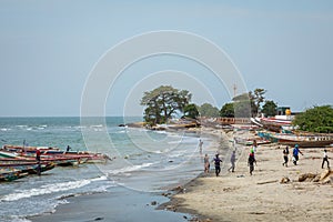 BARRA, THE GAMBIA - NOVEMBER 18, 2019: Pleople workingh at the beach in Barra, Gambia