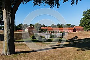 Barracks and buildings of Kastellet, the Citadel in Copenhagen with a tree in the foreground