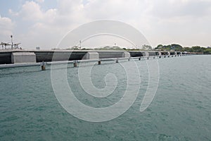 A barrage dam barrier wall stretching along an ocean reservoir