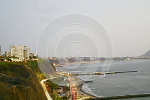 Barranco Peru coast with Pacific Ocean beach with the historic restaurant - Rosa Nautica - and a highway with traffic photo