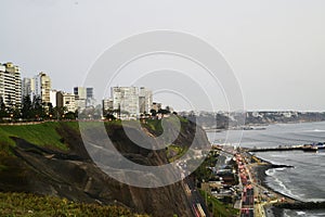 Barranco Peru coast with Pacific Ocean beach with the historic restaurant - Rosa Nautica - and a highway with traffic