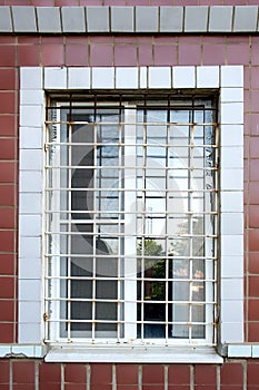 Barred window close-up. White grille on the window