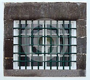 Barred window with green iron grid