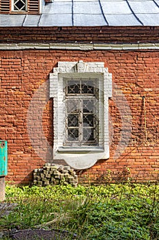 Barred window in an old brick house