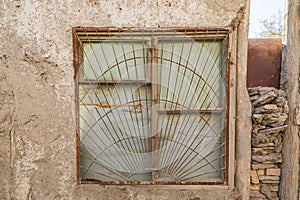 Barred window on an old building in Bukhara