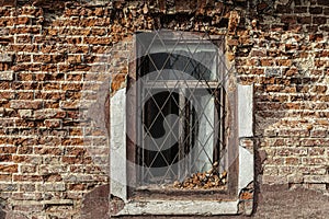 Barred window on an old crumbling brick wall