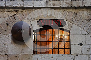 Barred window shined from within with a candelabrum