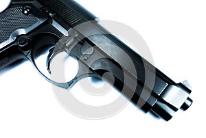 Barrel of a black gun, pistol lies on a white background. Close up