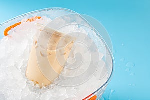 a barrel of milktea with tapiocas in an iced bucket at horizontal composition