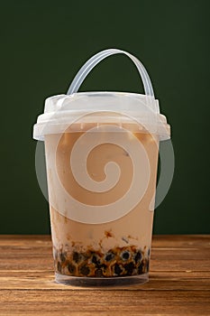 a barrel of milktea with tapiocas at vertical composition