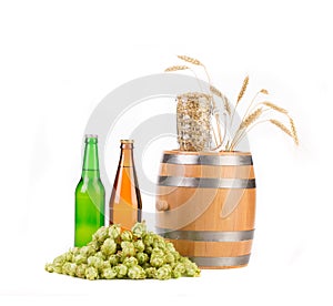 Barrel mug with hops and bottles of beer.