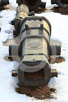 Barrel of old cannon on snow closeup