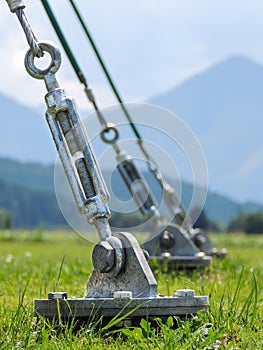 A barrel strainer anchored in grass.