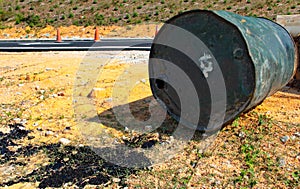 Barrel of tarmac spilled at the road side