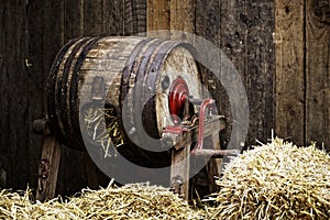 Barrel-type butter churn filled with straw