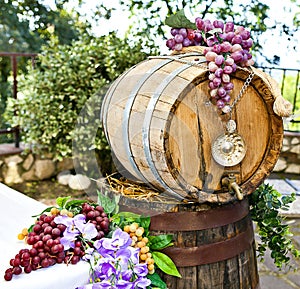 Barrel of wine with grape cones photo