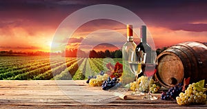 Barrel Wineglasses And Bottle In Vineyard