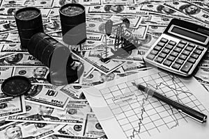 Barrels with oil, a calculator, a neftechka, a schedule of oil imports and exports against