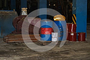 Barrels of oil and fuel, lubricating materials in a dark warehouse at the industrial refinery chemical petrochemical