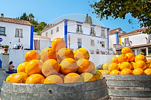 Barrels with oranges. Obidos, Portugal photo