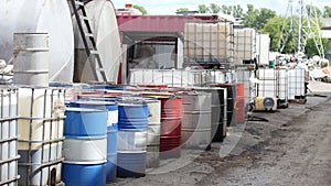 Barrels of used oil stand in a row on the street - recycling