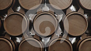 Barrels of wine, whiskey, bourbon liqueur or cognac in the basement. Aging of alcohol in oak barrels in warehouse. Wine
