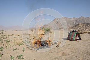 Barren desert landscape in hot climate with campfire