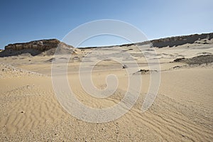 Barren desert landscape in hot climate with mountain rock formation