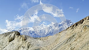 Barren landscape and snow-capped mountains on the trail from Muktinath to Kagbeni  Annapurna Circuit  Nepal