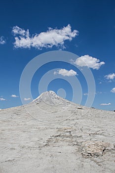 Barren Peak Under Small Clouds