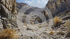 A barren rocky canyon its walls pockmarked with abandoned mineshafts and the hollow echoes of pickaxes still ringing in photo