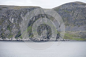 Barren rocky cape at Rolvsoya island , Norway