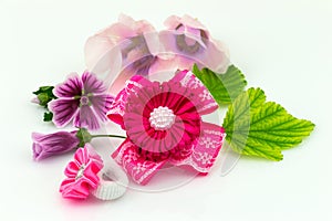 Barrette with ribbon and elastic, flowers and green leaf isolated on white background