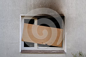 Barricaded window after the fire damage in an apartment house, concept for arson, negligence and insurance