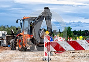 Barrier at a road construction site. The construction site is protected by warning signs