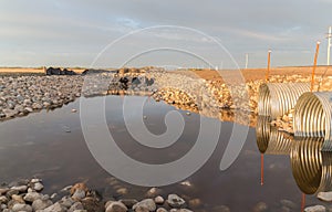 Rock and steel culverts used as a barrier photo