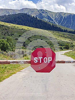 Barrier with STOP road sign - Movement without stopping is prohibited