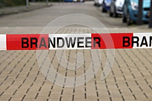 Barrier tape with Dutch text Brandweer translated fire brigade