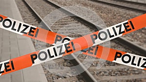 Barrier tape on railway station with the German word POLIZEI (police)