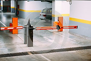 Barrier to an underground parking lot with parked cars